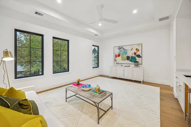 a living room with furniture and kitchen view