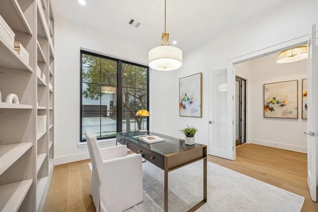 a living room with furniture a chandelier and a large window