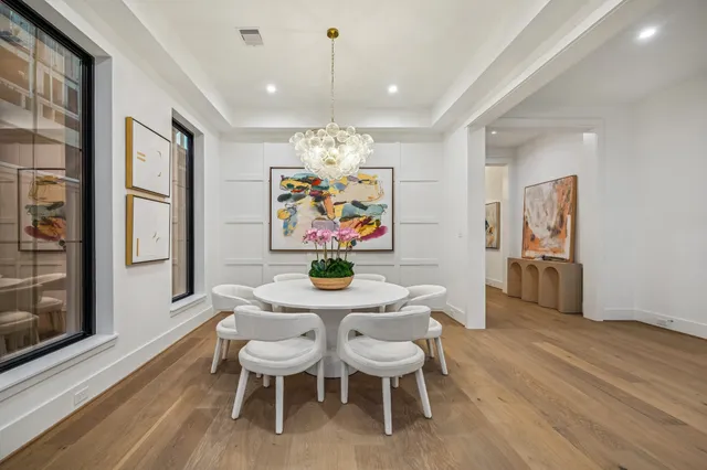 a view of a dining room with furniture wooden floor and chandelier