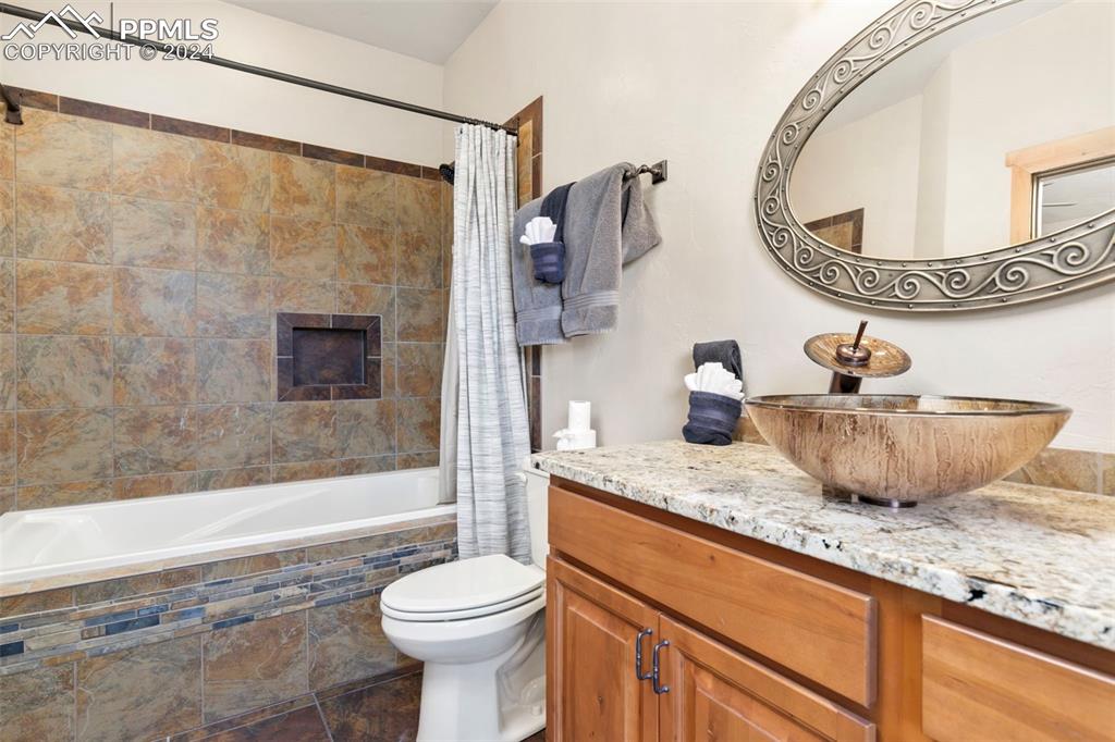 252 Running Elk Point Divide, CO 80814 - Photo 37 of 48 a bathroom with a granite countertop sink mirror vanity and toilet