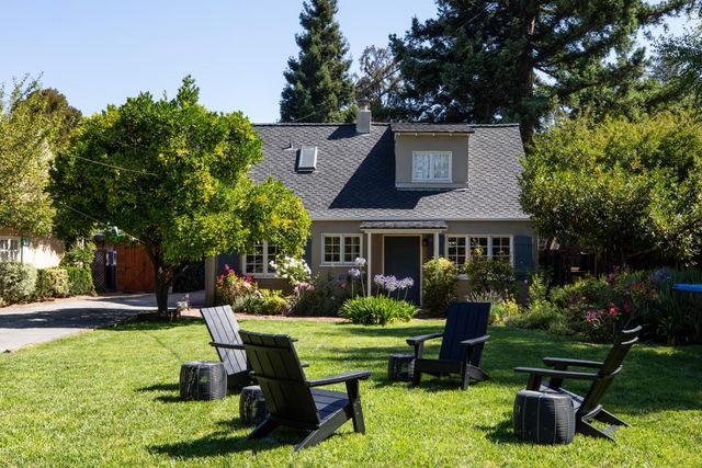 a front view of a house with a garden