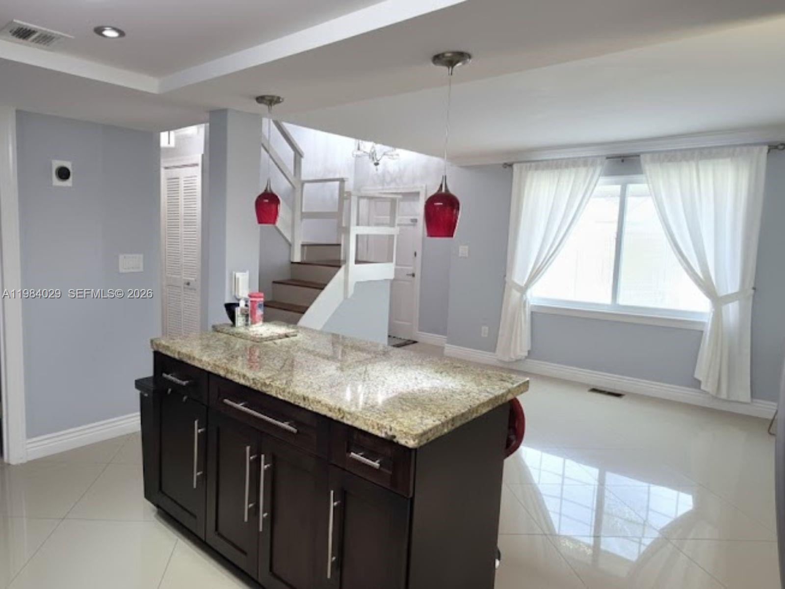 3282 North Pine Island Road, Unit 301 Sunrise, FL 33351 - Photo 7 of 22 a view of kitchen island with stainless steel appliances granite countertop sink and cabinets