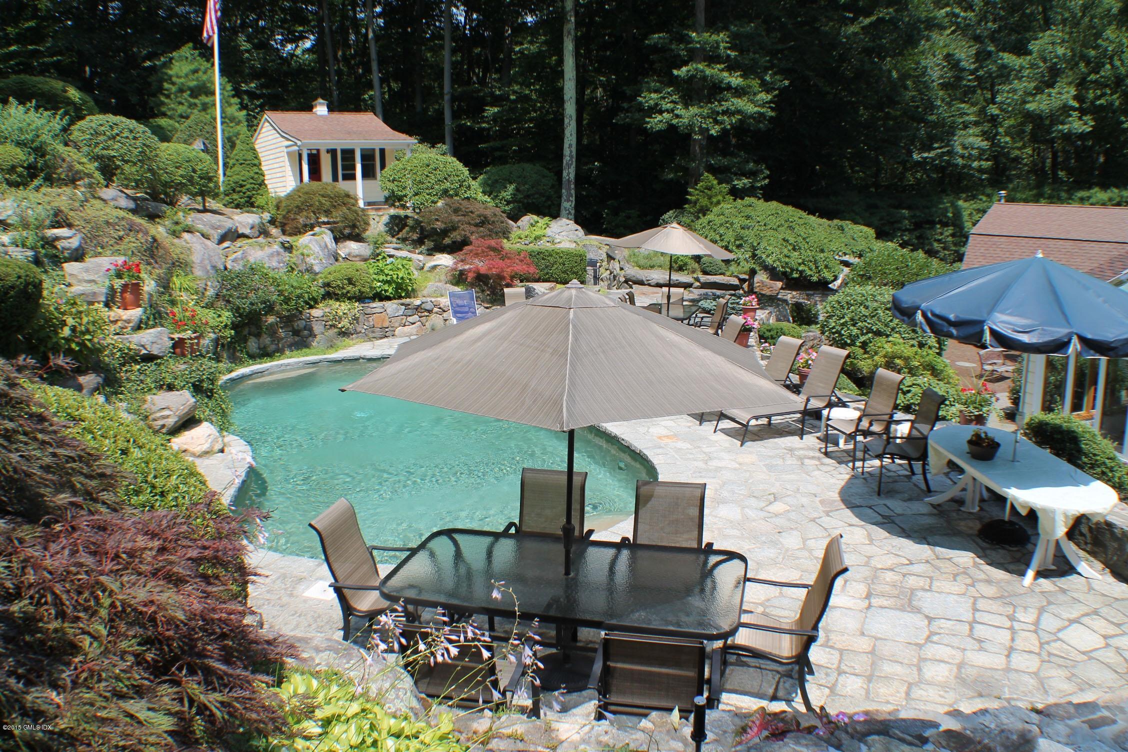 a view of an chairs and table in backyard