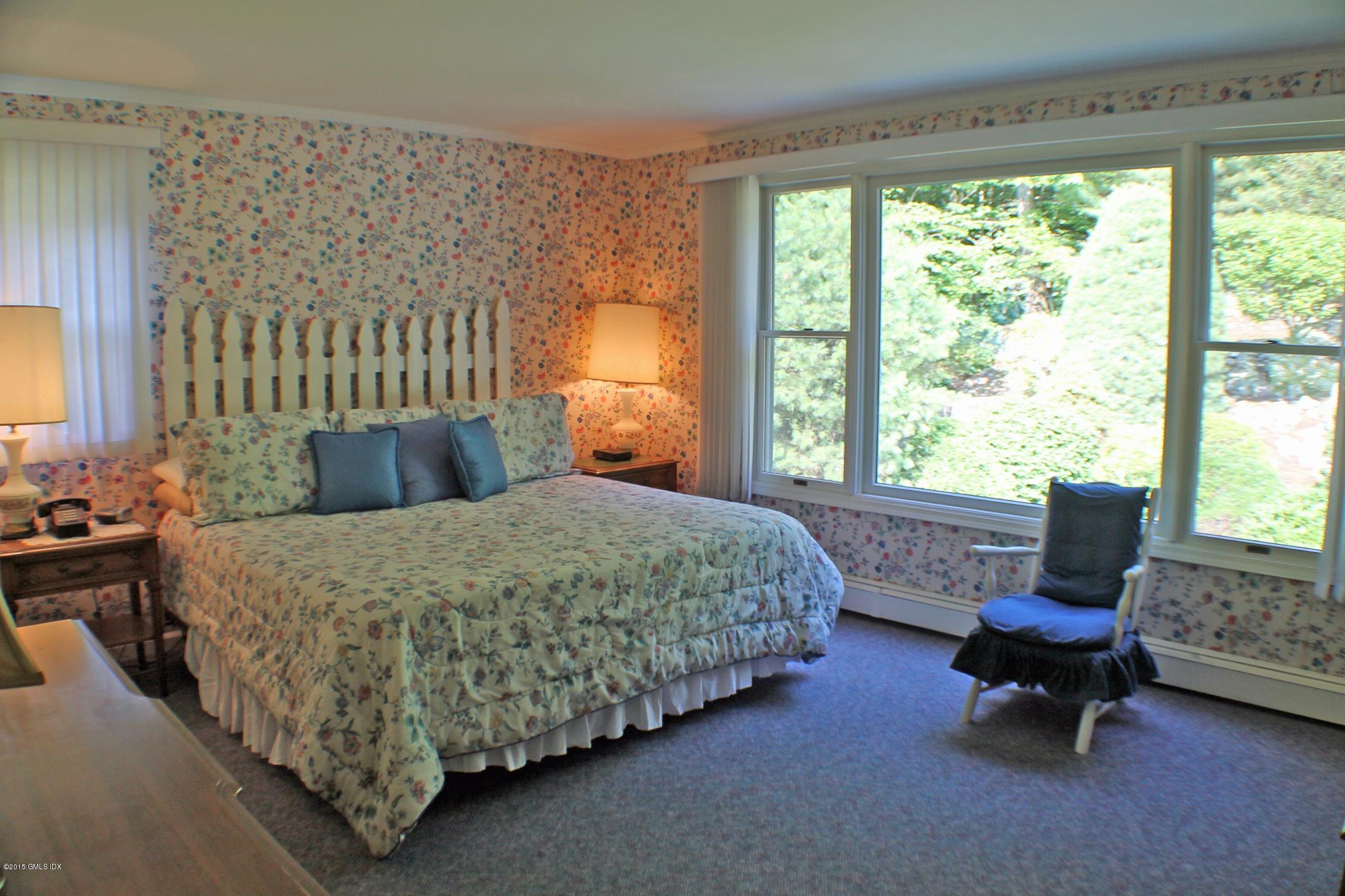 237 Chestnut Hill Road Stamford, CT 06903 - Photo 11 of 18 a bed sitting in a bedroom next to a window