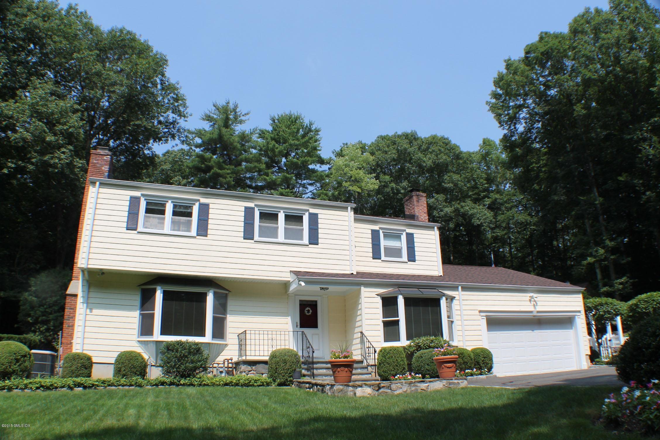 237 Chestnut Hill Road Stamford, CT 06903 - Photo 2 of 18 a front view of a house with a garden and plants