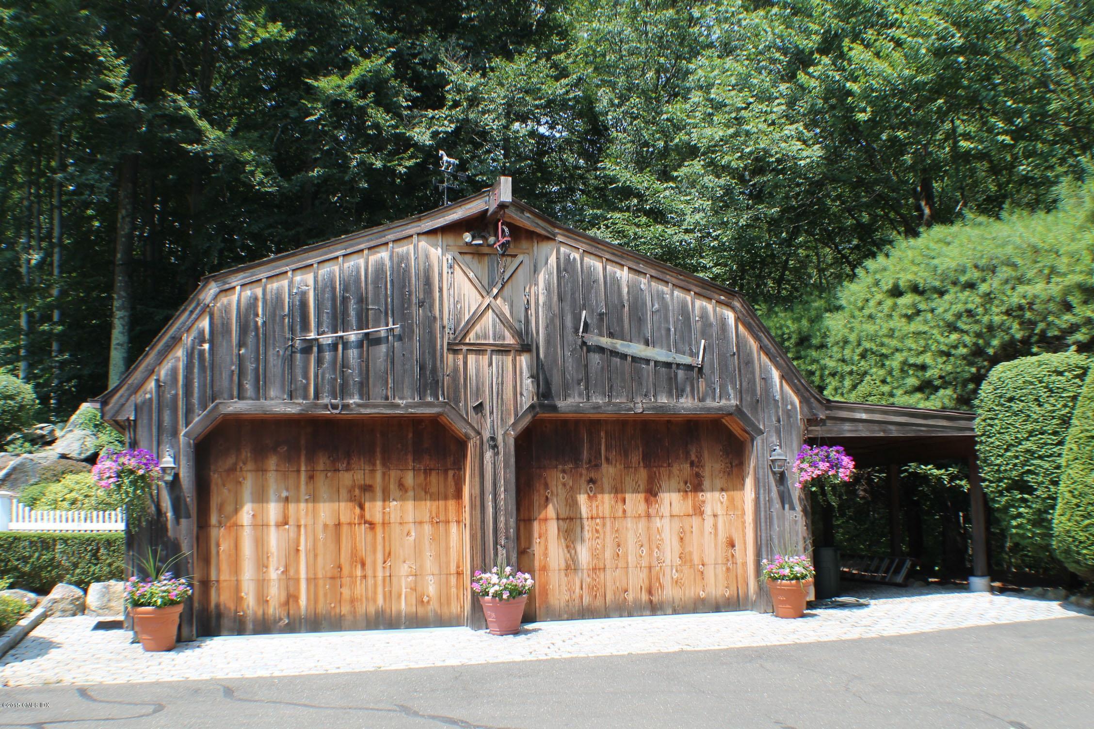 237 Chestnut Hill Road Stamford, CT 06903 - Photo 4 of 18 a view of barn with large tree and wooden fence