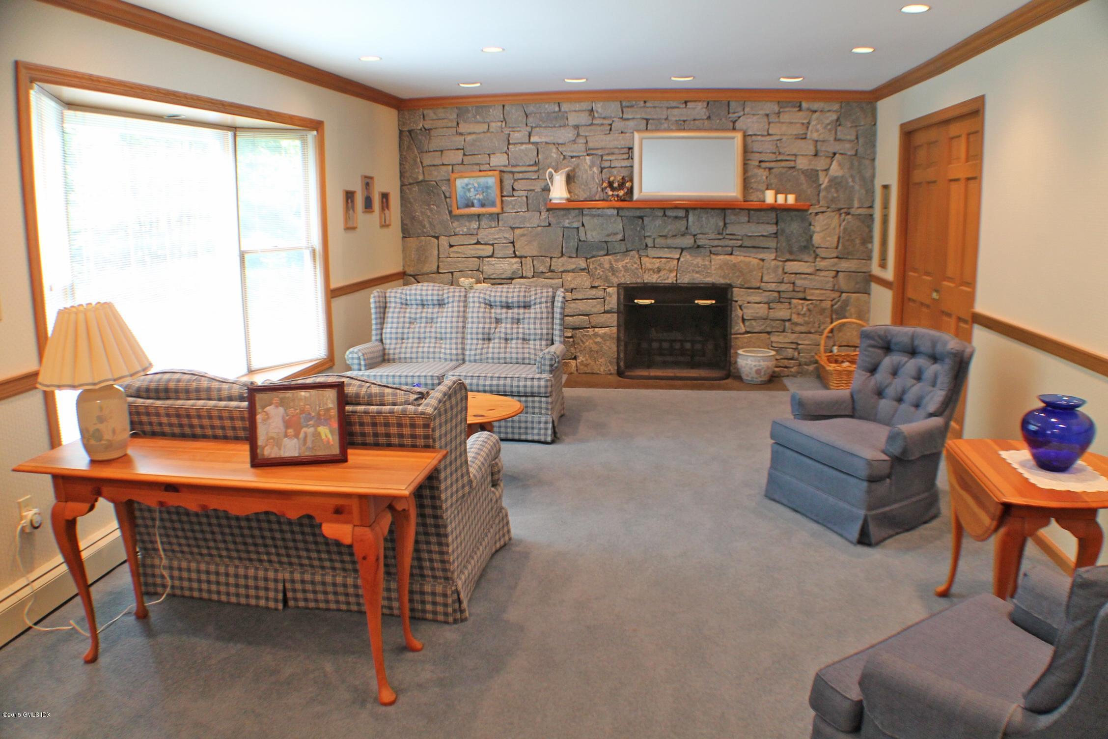237 Chestnut Hill Road Stamford, CT 06903 - Photo 5 of 18 a living room with furniture a fireplace and a window