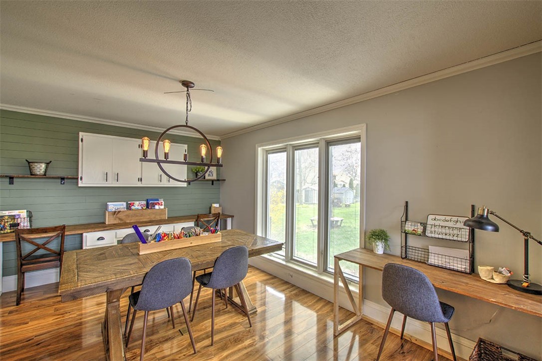 4670 Trevino Lane Decatur, IL 62526 - Photo 9 of 39 a dining room with furniture a chandelier and wooden floor