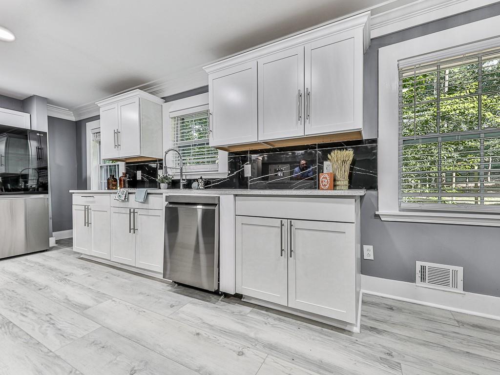 1564 Bubbling Creek Road Northeast Brookhaven, GA 30319 - Photo 14 of 34 a kitchen with white cabinets and white appliances