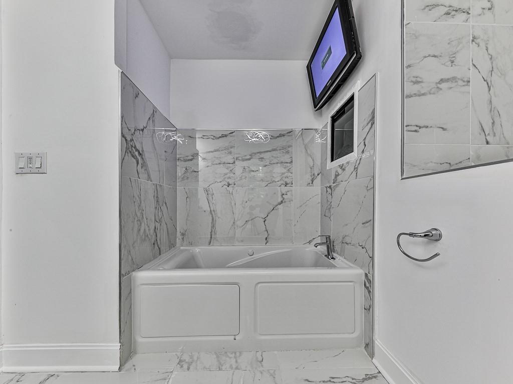 1564 Bubbling Creek Road Northeast Brookhaven, GA 30319 - Photo 22 of 34 a spacious bathroom with a bathtub and shower