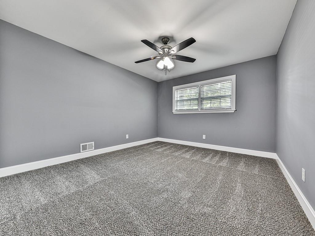 1564 Bubbling Creek Road Northeast Brookhaven, GA 30319 - Photo 24 of 34 an empty room with a window and a fan
