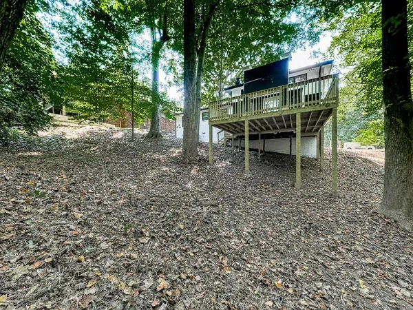 a backyard of a house with table and chairs