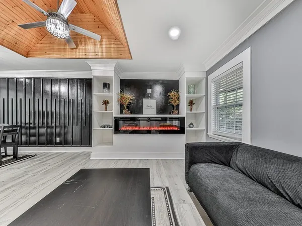 a living room with furniture and a kitchen