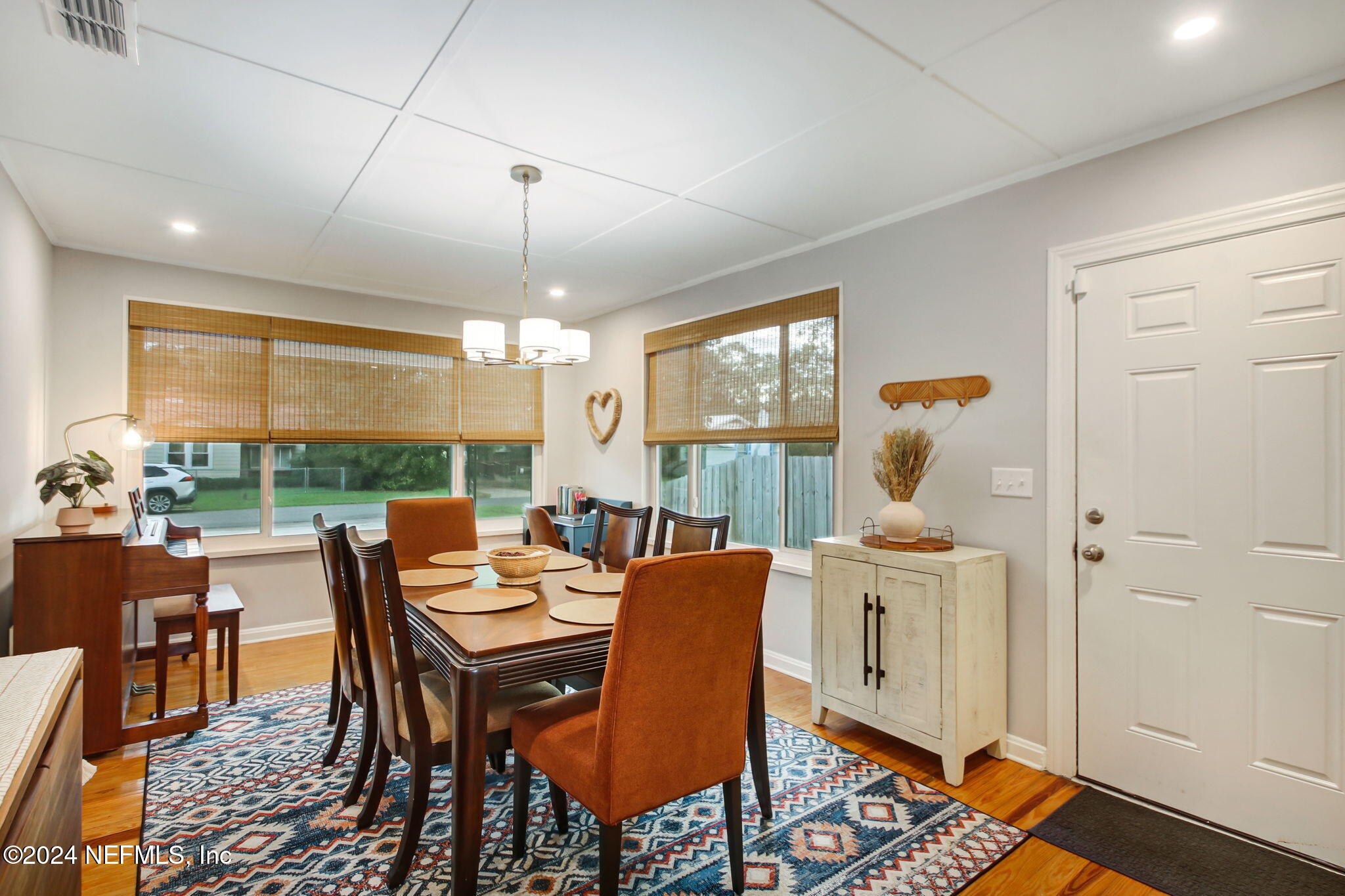 4635 Colonial Avenue Jacksonville, FL 32210 - Photo 20 of 42 a dining room with furniture a rug and a chandelier