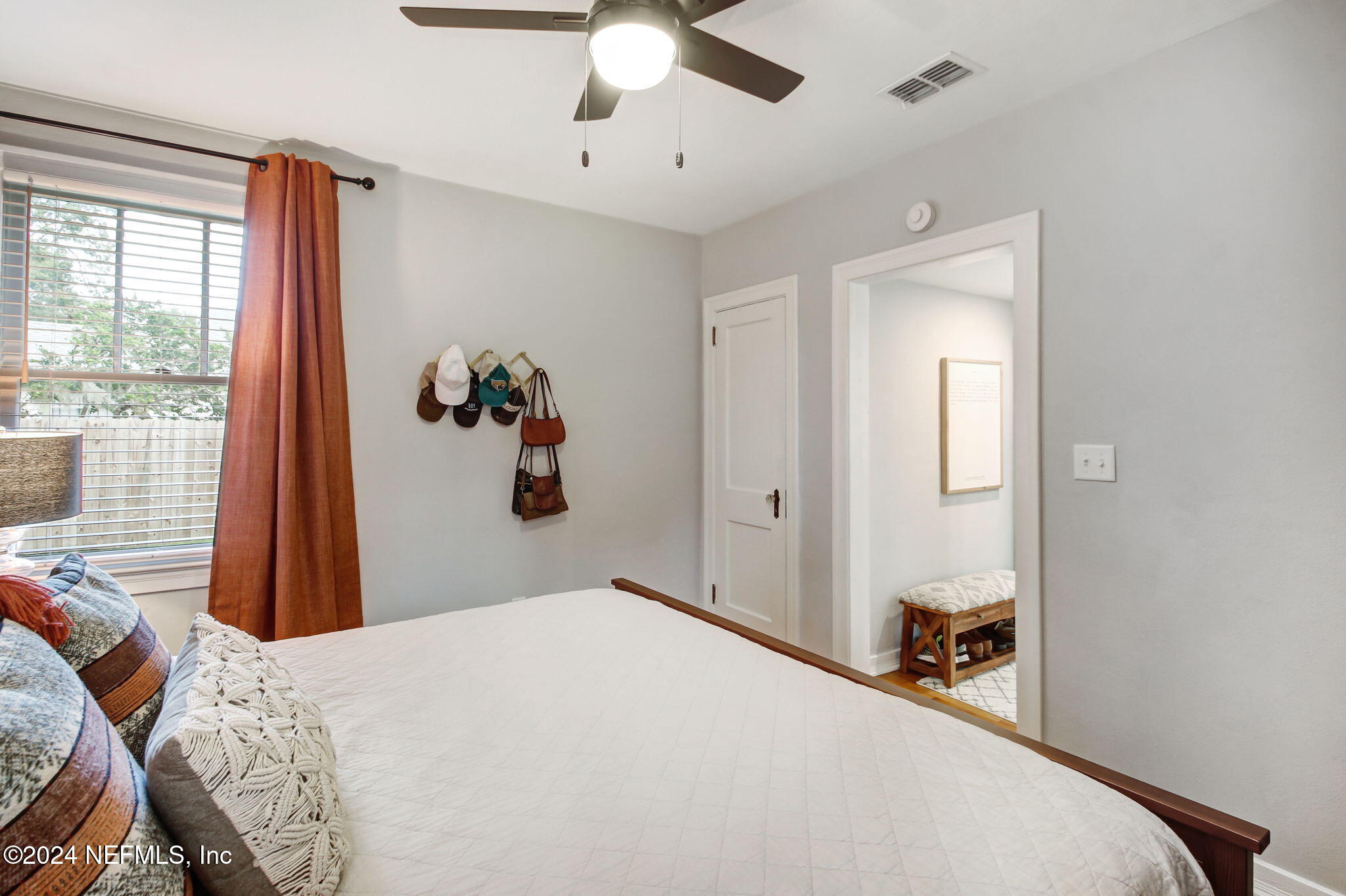 4635 Colonial Avenue Jacksonville, FL 32210 - Photo 25 of 42 a bedroom with a large bed and a chandelier