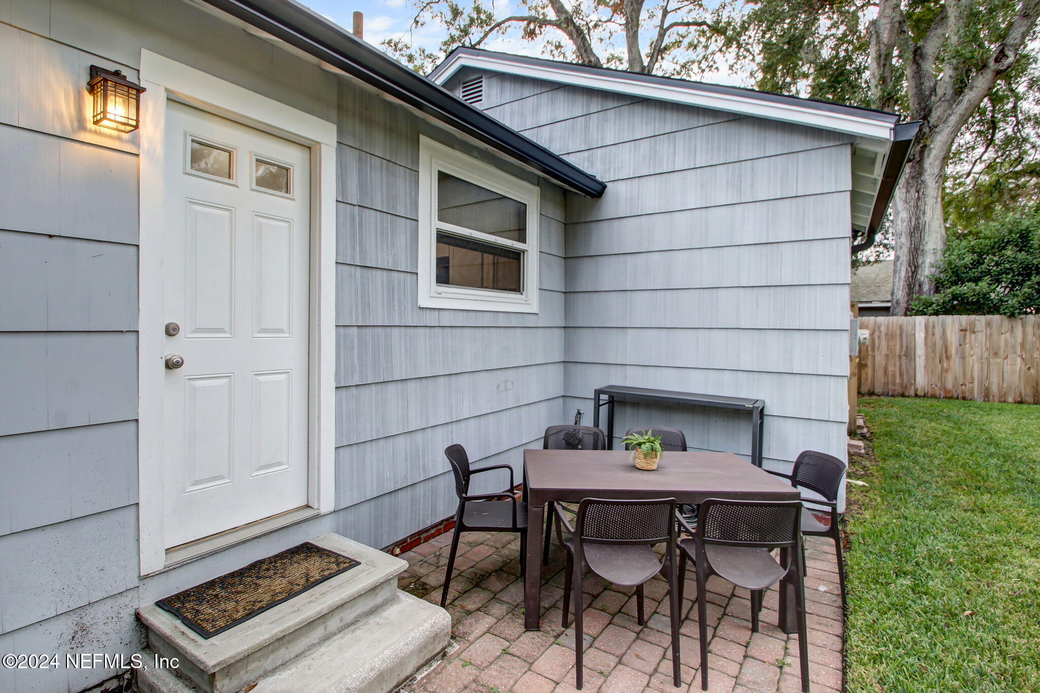 4635 Colonial Avenue Jacksonville, FL 32210 - Photo 34 of 42 a backyard of a house with table and chairs
