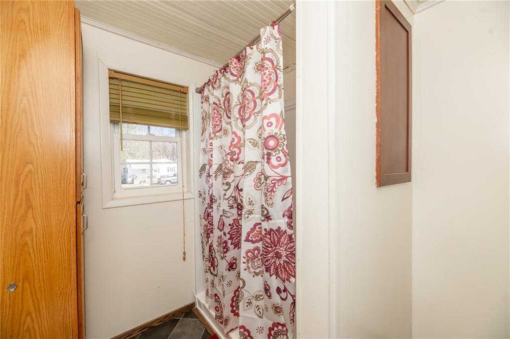 3275 Shellbark Road Armagh, PA 15920 - Photo 14 of 24 a bathroom with a window and a shower curtain