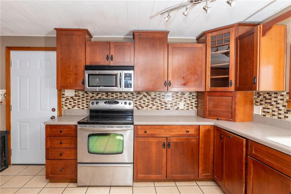 3275 Shellbark Road Armagh, PA 15920 - Photo 7 of 24 a kitchen with stainless steel appliances wooden cabinets and a stove top oven