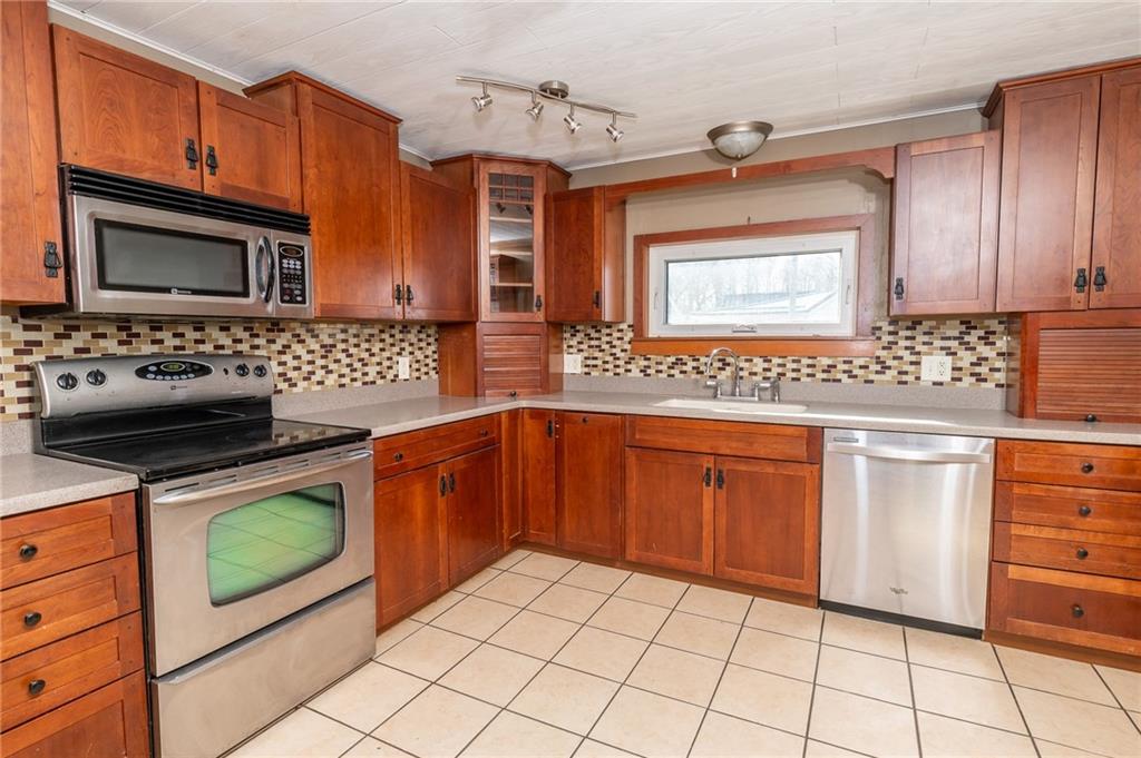 3275 Shellbark Road Armagh, PA 15920 - Photo 8 of 24 a kitchen with stainless steel appliances granite countertop a stove microwave and sink