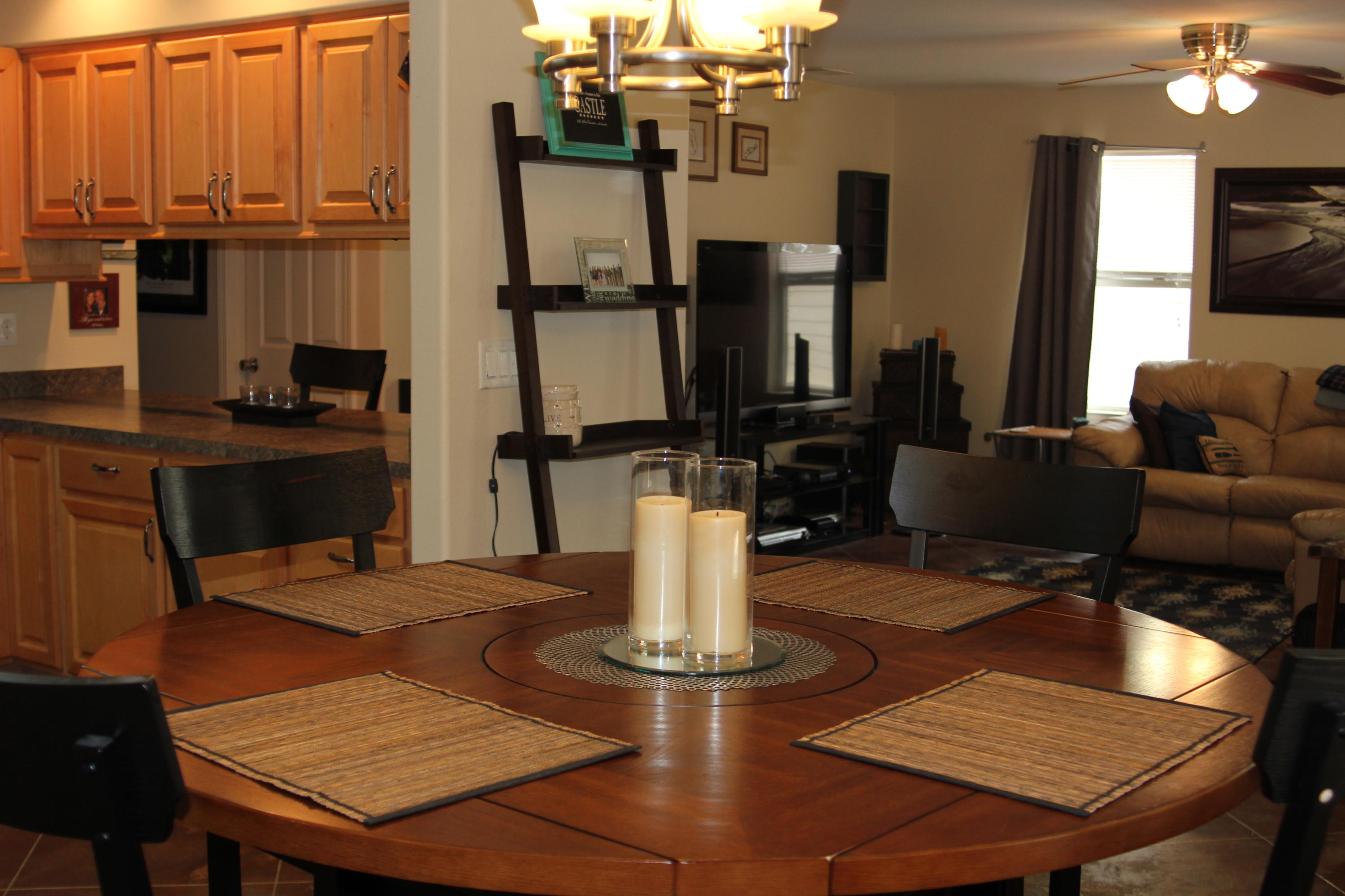 85 Indian Woman Road Santa Rosa Beach, FL 32459 - Photo 13 of 44 a living room with dining table a flat screen tv and kitchen view