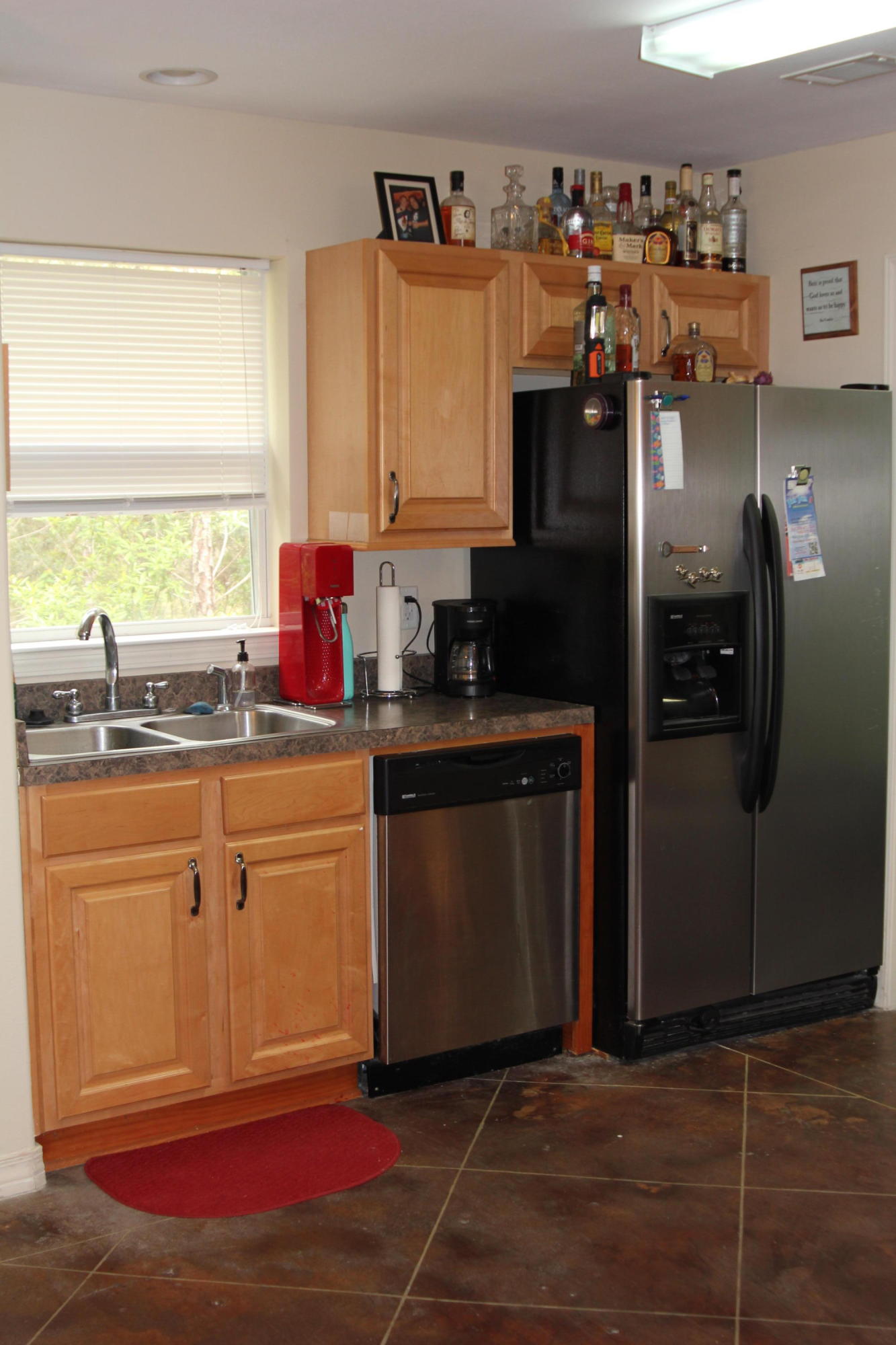 85 Indian Woman Road Santa Rosa Beach, FL 32459 - Photo 15 of 44 a kitchen with stainless steel appliances kitchen island granite countertop a refrigerator stove top oven and sink