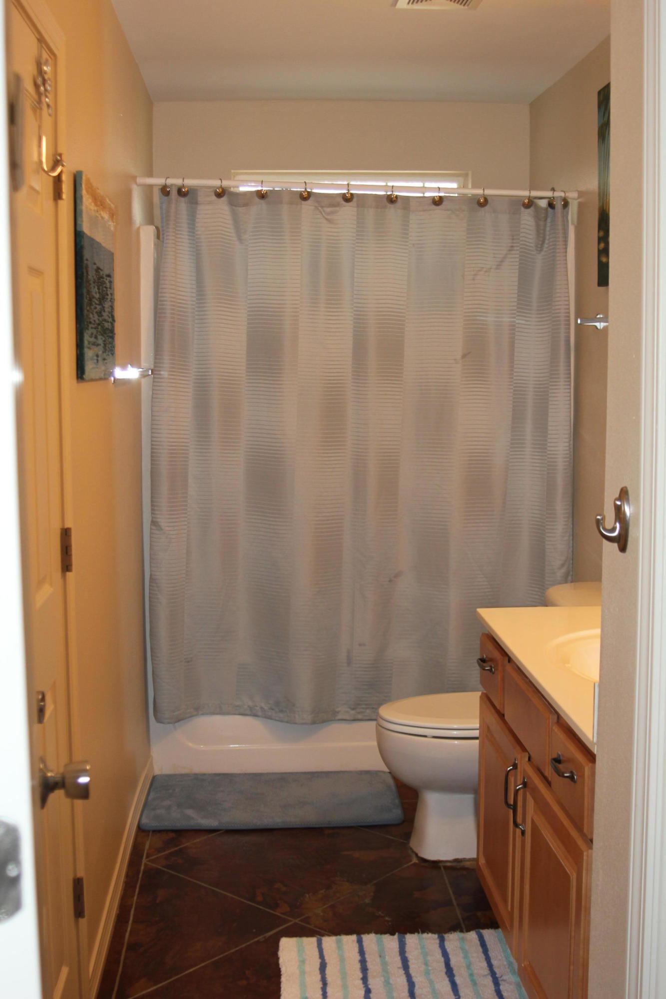85 Indian Woman Road Santa Rosa Beach, FL 32459 - Photo 22 of 44 a bathroom with a shower curtain and a toilet
