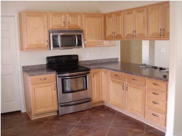 85 Indian Woman Road Santa Rosa Beach, FL 32459 - Photo 7 of 44 a kitchen with granite countertop white cabinets and stainless steel appliances