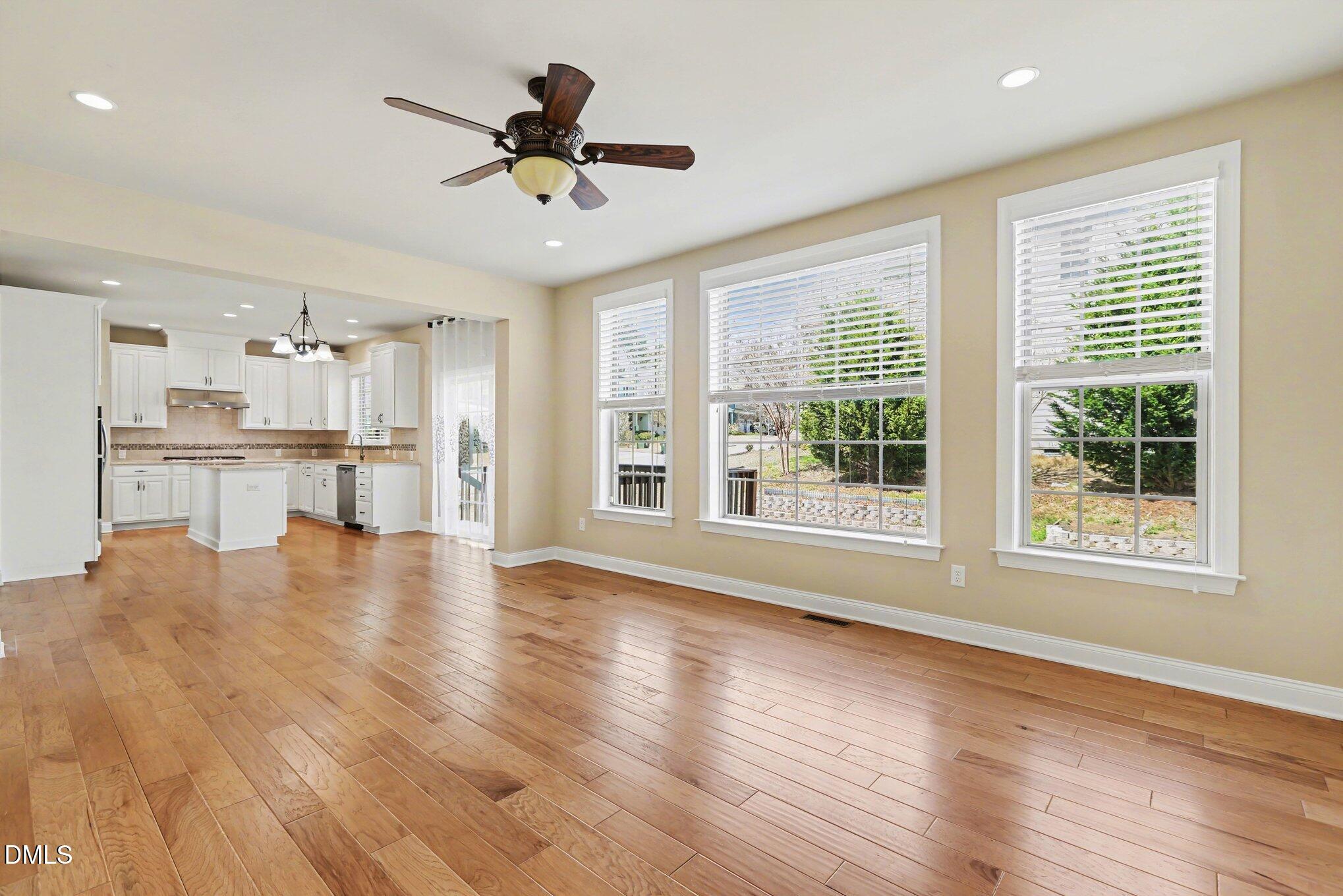 351 Gartrell Way Cary, NC 27519 - Photo 10 of 51 a view of an empty room with wooden floor and a window
