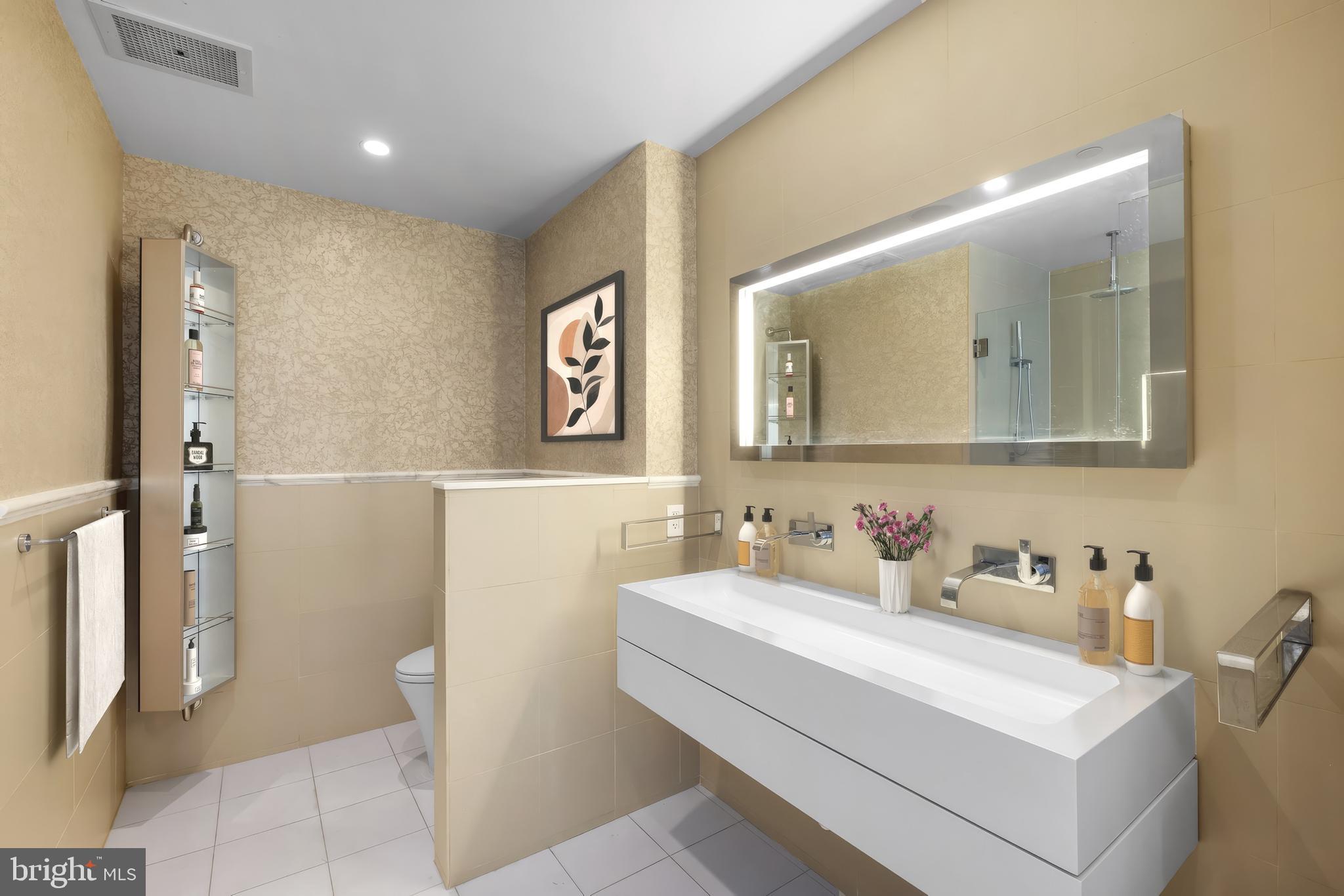 101 Walnut Street, Unit 6 Philadelphia, PA 19106 - Photo 11 of 21 a bathroom with a sink a toilet and mirror