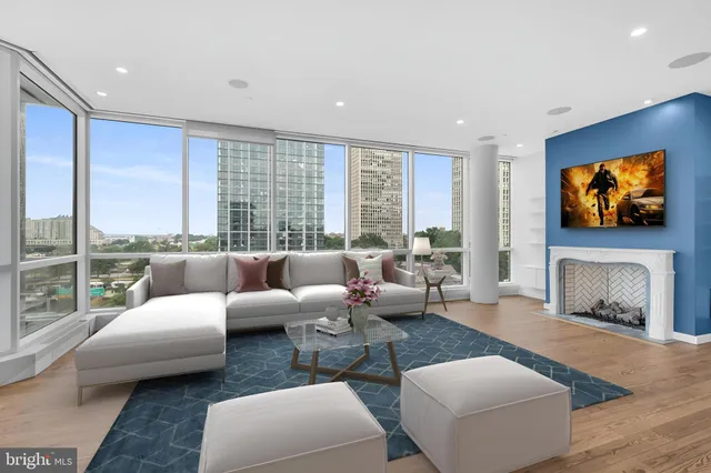 a living room with furniture a large window and a flat screen tv