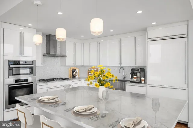 a kitchen with stainless steel appliances granite countertop a sink and a stove