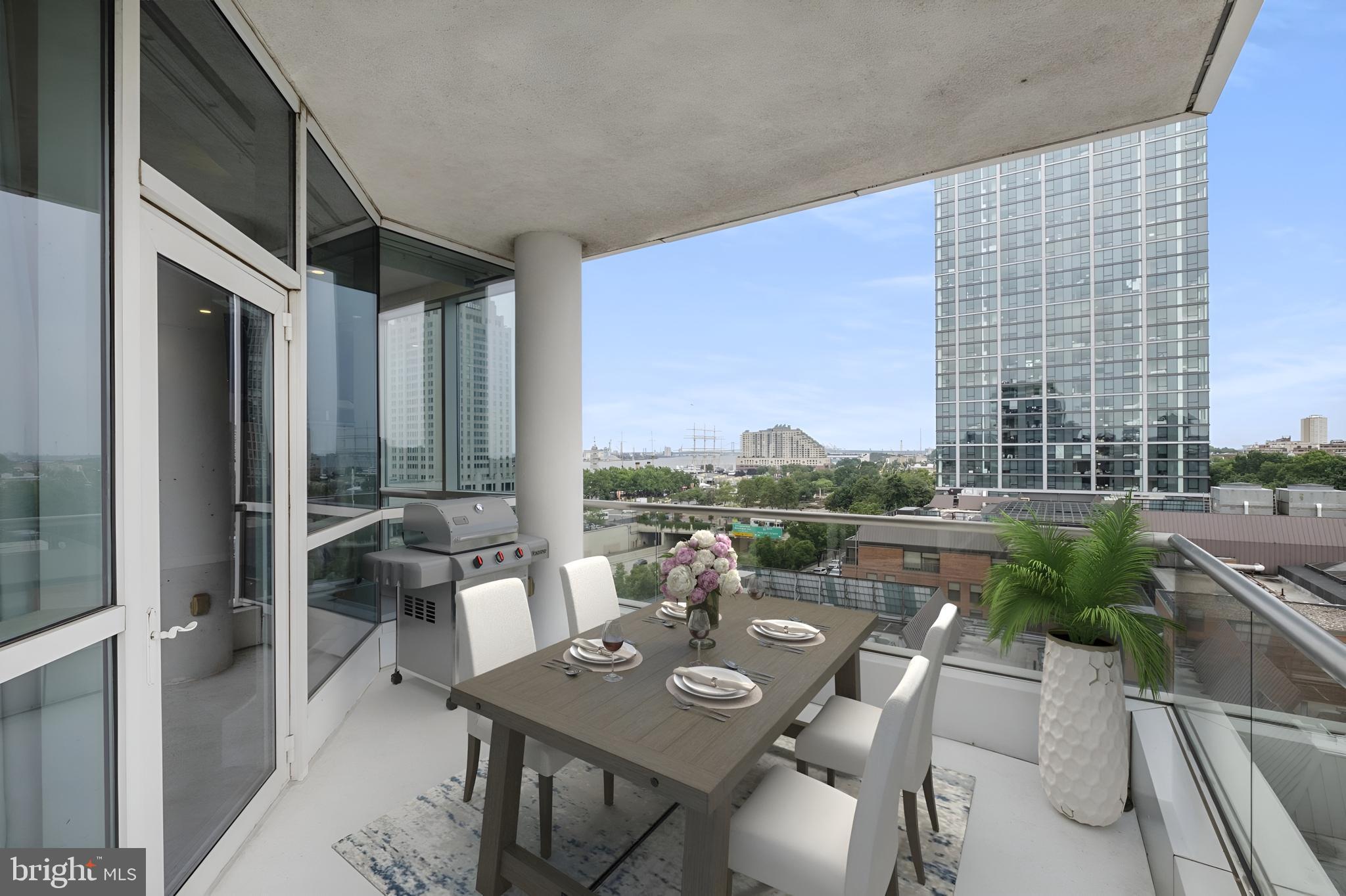101 Walnut Street, Unit 6 Philadelphia, PA 19106 - Photo 5 of 21 a view of a patio with couches and table and chairs and potted plants