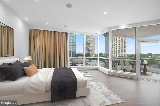 a bedroom with a large bed and a large window