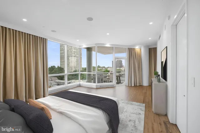 a bedroom with a bed and large window