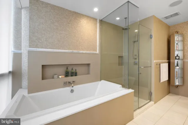a bathroom with a bathtub and a shower