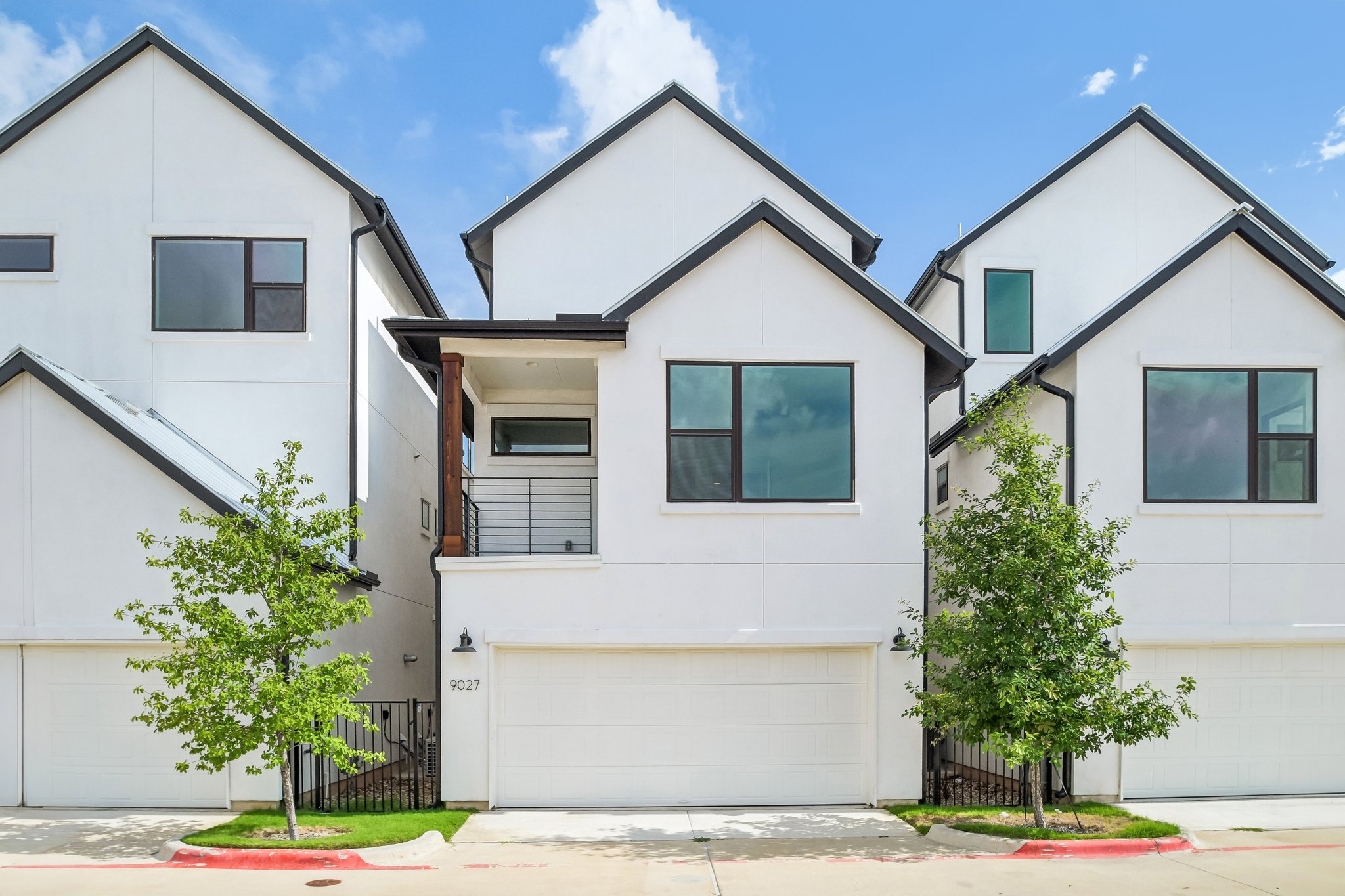 9027 Cattle Baron Path Austin, TX 78747 - Photo 30 of 32 Modern townhomes feature clean lines, a two-car garage, and a charming upper-level balcony.