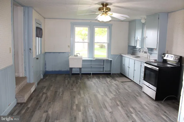a kitchen with sink and cabinets