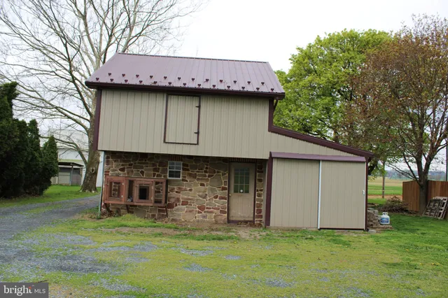 a view of a backyard with a large tree
