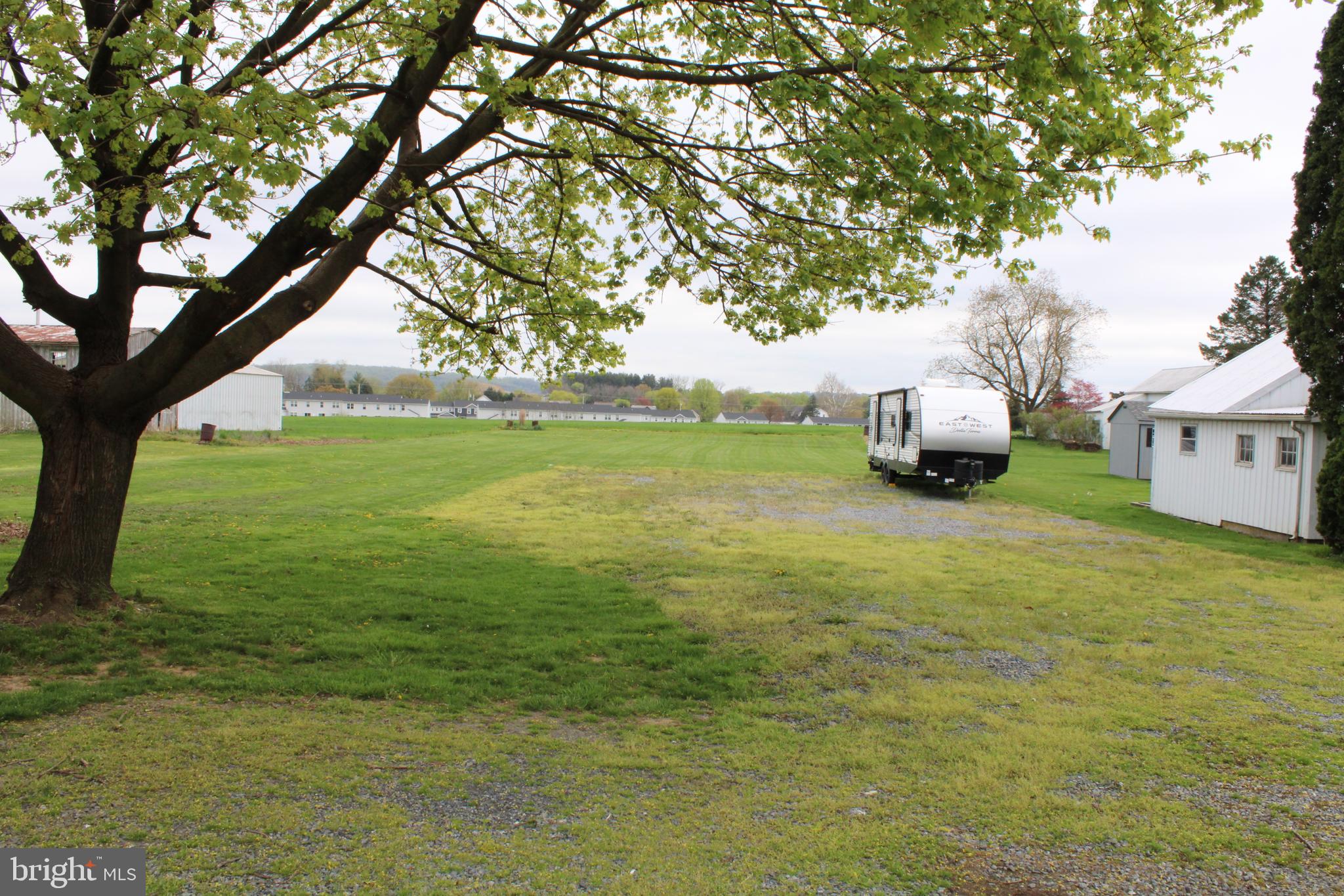 165 Short Road Stevens, PA 17578 - Photo 10 of 19 a backyard of a house with table and chairs under a large tree
