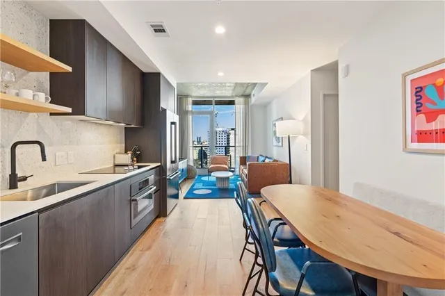 a large kitchen with a table and chairs