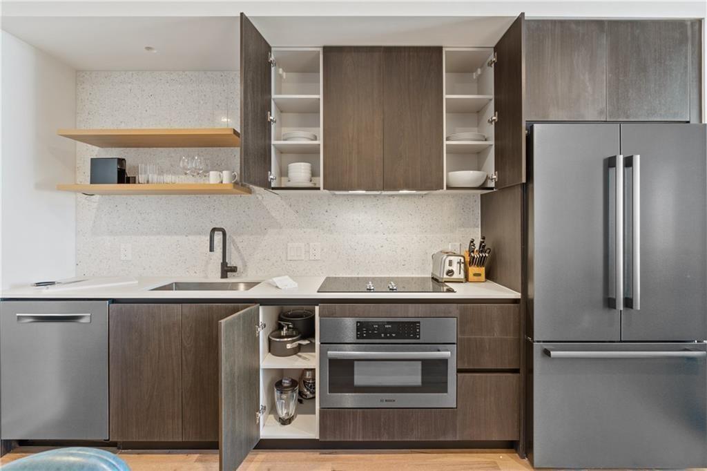 48 East Avenue, Unit 1503 Austin, TX 78701 - Photo 11 of 40 a kitchen with stainless steel appliances granite countertop a refrigerator a sink and a stove