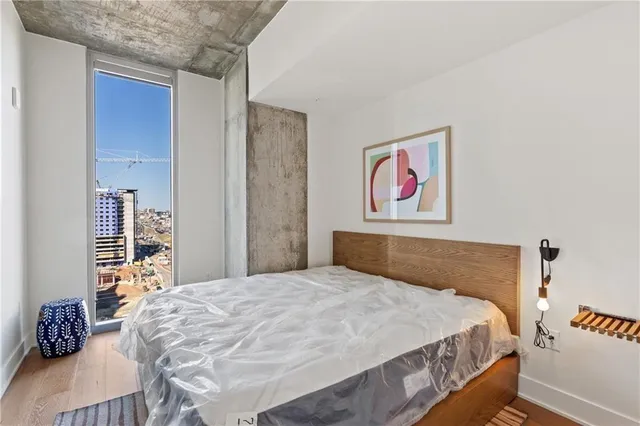 a bedroom with a large bed and a book shelf
