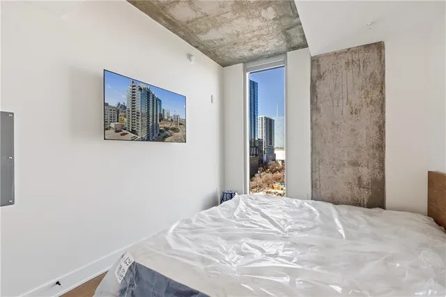 a bedroom with a bed and a window