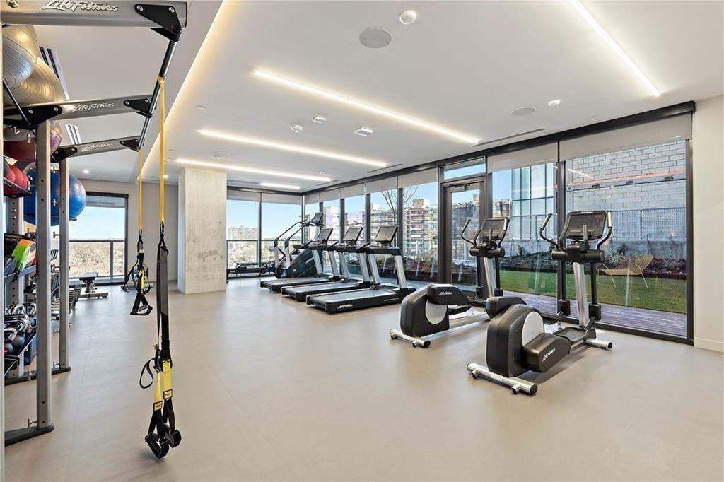 48 East Avenue, Unit 1503 Austin, TX 78701 - Photo 22 of 40 a room with gym equipment and large windows