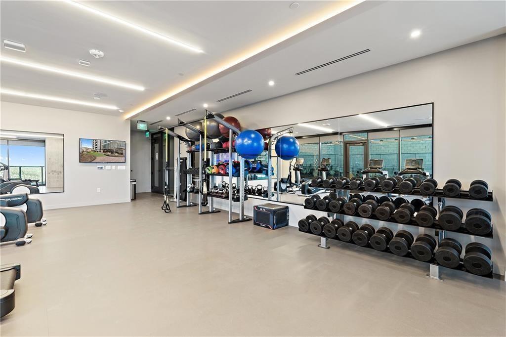 48 East Avenue, Unit 1503 Austin, TX 78701 - Photo 24 of 40 a living room with lots of furniture and clutter
