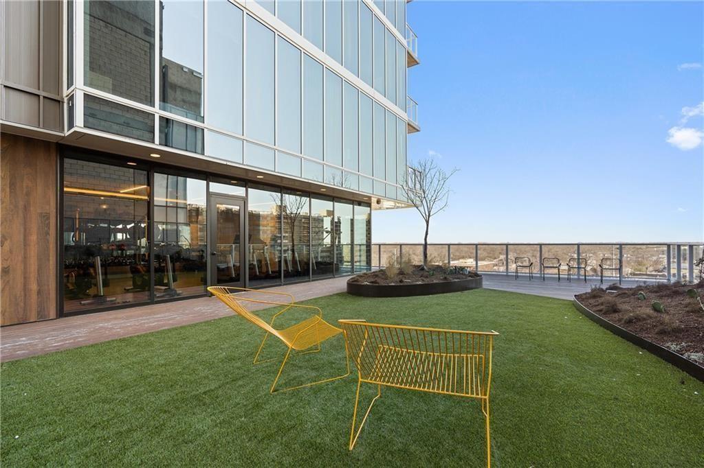 48 East Avenue, Unit 1503 Austin, TX 78701 - Photo 26 of 40 a view of a swimming pool with lawn chairs and couches with wooden fence