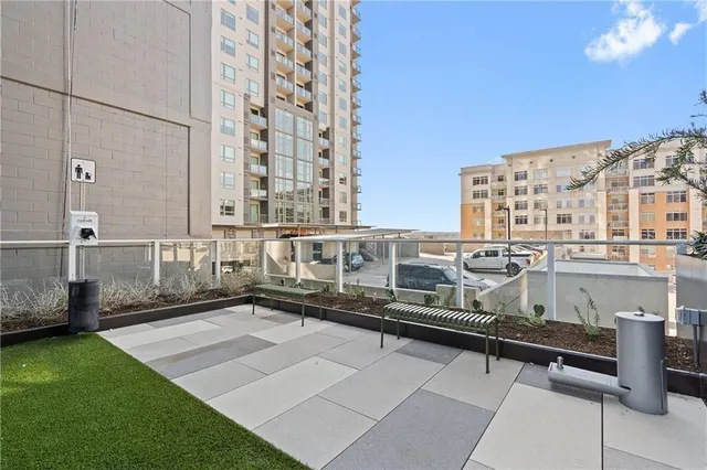 a balcony with a table and chairs