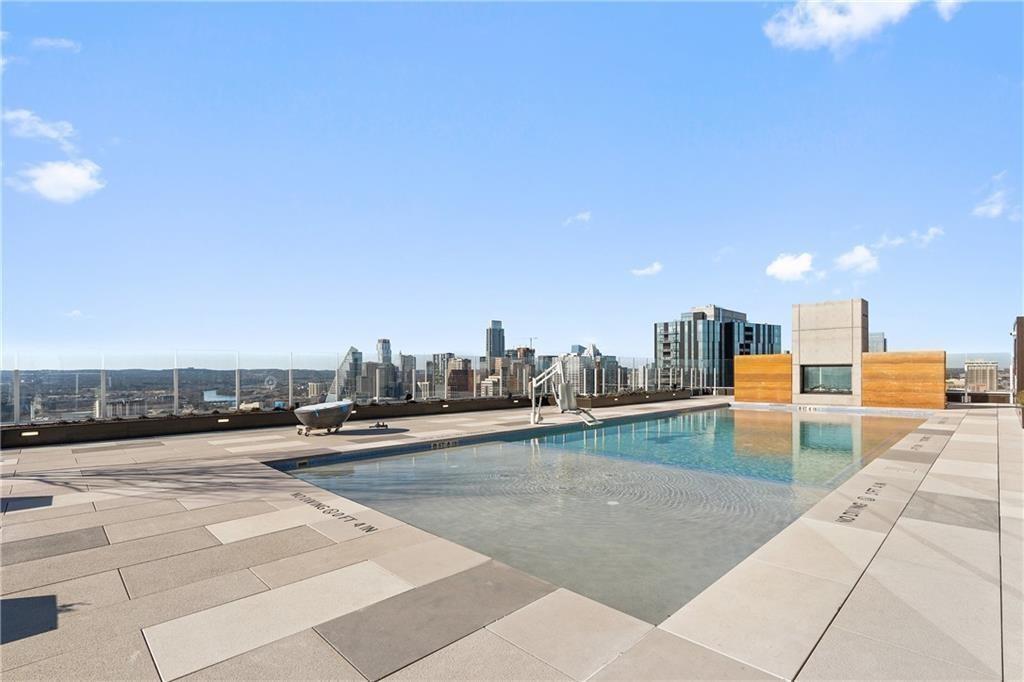 48 East Avenue, Unit 1503 Austin, TX 78701 - Photo 32 of 40 a swimming pool with outdoor seating and yard