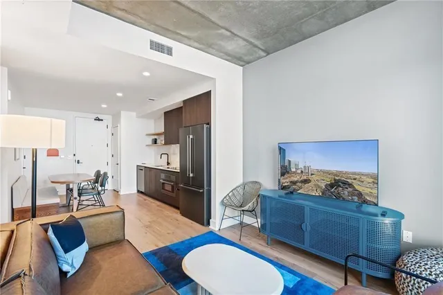 a living room with furniture kitchen view and a window