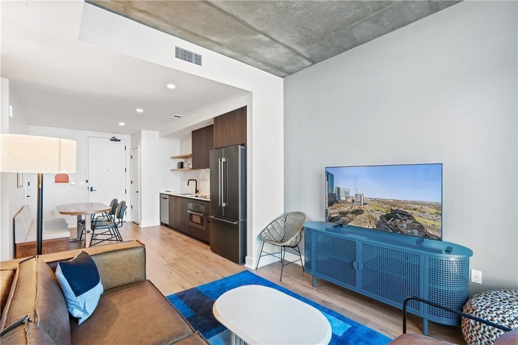 48 East Avenue, Unit 1503 Austin, TX 78701 - Photo 4 of 40 a living room with furniture kitchen view and a window